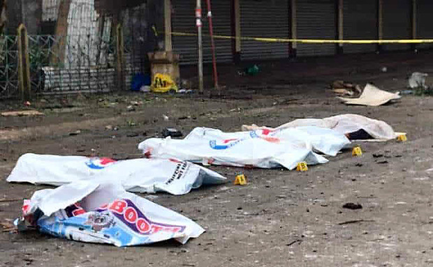 The bodies of some of the bombing victims are covered with white sheets after the two explosions in Jolo, capital of the southern Philippine province of Sulu, Jan. 27, 2019. [HO/Philippine military]