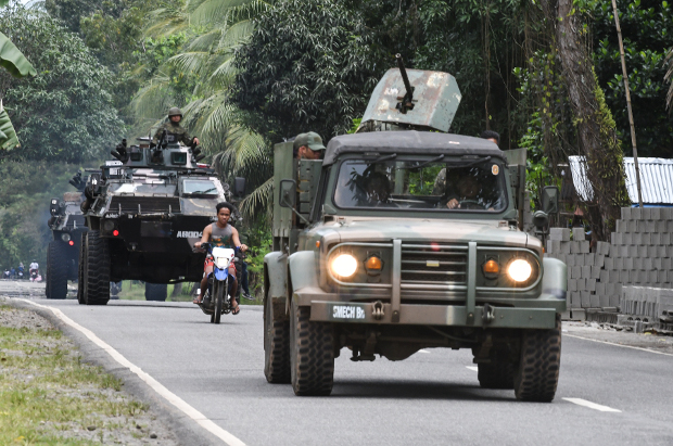 An army tank and an armored jeep patrol a highway near the town of Kauwagan in the southern Philippine province of Lanao del Norte, Feb. 6, 2019. [Froilan Gallardo/BenarNews]