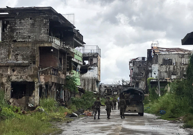 Security forces patrol the former main battle area in the southern Philippine city of Marawi, where the military engaged pro-Islamic State militants in five months of vicious clashes last year, Oct. 16, 2018. 