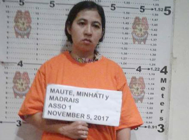 Indonesian Minhati Madrais, widow of slain militant Omarkhayam Maute, holds a sign with her name during her booking at a police station in the southern Philippine city of Iligan following her arrest, Nov. 5, 2017. [Police HO]