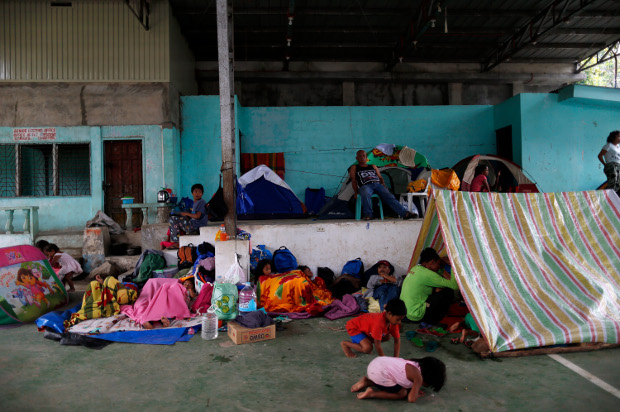 Residents huddle at a covered public plaza in the southern Philippine city of Kidapawan after a powerful quake hit the area, Oct. 30, 2019. [Jeoffrey Maitem/BenarNews]