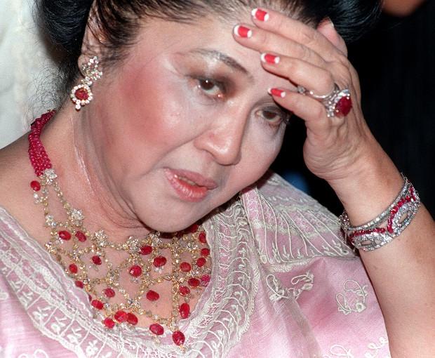 Former Philippine first lady Imelda Marcos is photographed wearing jewelry adorned with rubies and diamonds during her 70th birthday party at a luxury hotel in Manila, July 2, 1999. [AP]