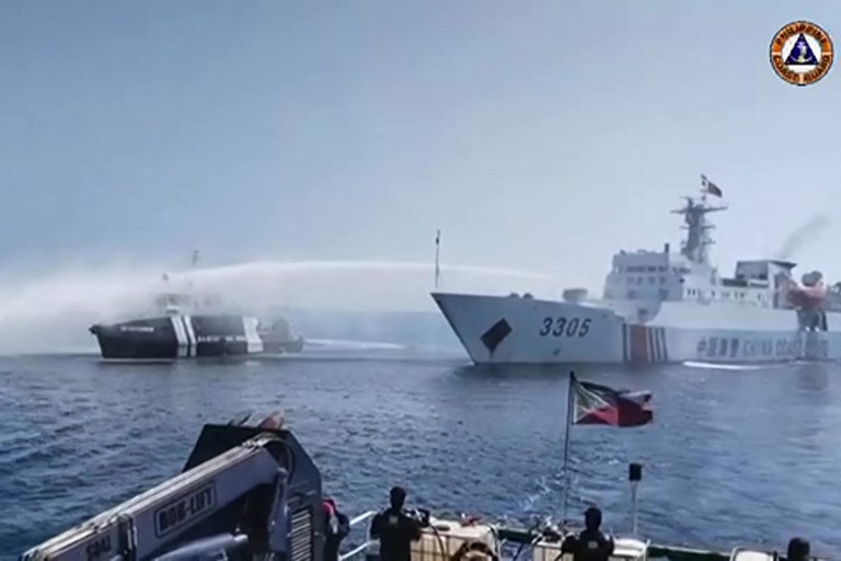A Chinese Coast Guard ship uses a water cannon to douse a Philippine Bureau of Fisheries and Aquatic Resources vessel near Scarborough Shoal, Dec. 9, 2023. (Image from Philippine Coast Guard video via AFP)