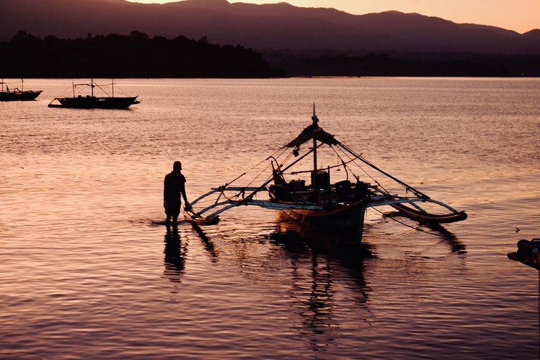 ENG_PAC_SCSseries2.7 A fisherman positions his boat after unloading his catch at dawn in Masinloc, Feb 27, 2024. (Jojo Riñoza/BenarNews)