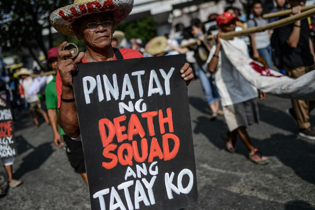 Friends and relatives of those victimized by extrajudicial killings in the Philippine drug war join other protesters for a “day of mourning and resistance” in Manila, Aug. 20, 2019. [Jojo Rinoza/BenarNews]