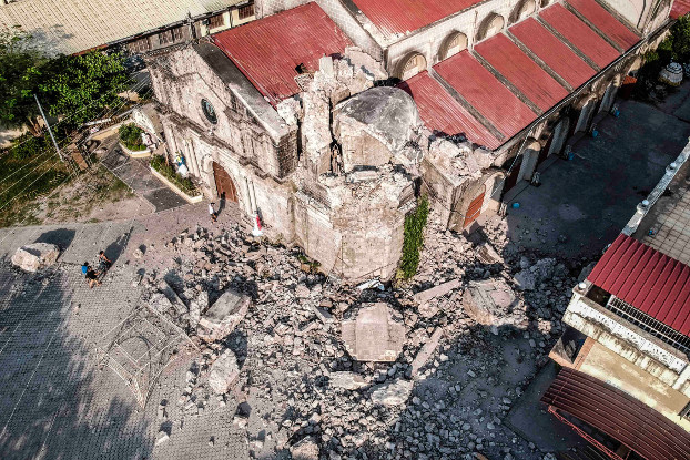 In this photo taken from a drone, blocks of concrete from the collapsed belfry of St. Catherine of Alexandria Parish Church are scattered in front of the church facade in Porac, April 23, 2019. [Jojo Rinoza/BenarNews]