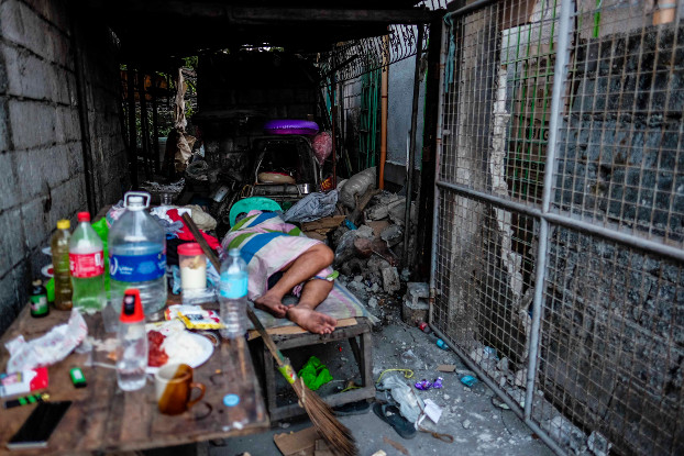 A man sleeps outside his house in Porac after Monday’s earthquake, April 23, 2019. [Jojo Rinoza/BenarNews]