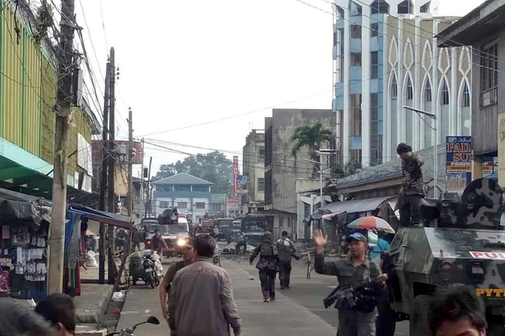 Philippine soldiers and police cordon off the area after two bombs exploded outside a Roman Catholic church in Jolo, Jan. 27, 2019. (Photo: WesMinCom Armed Forces of the Philippines Via AP)