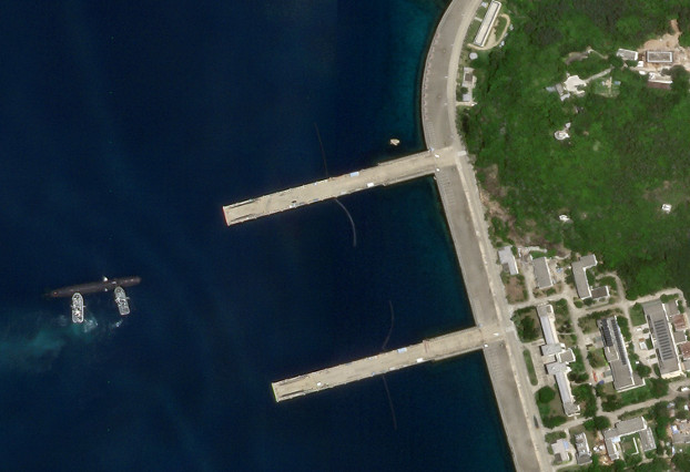 Satellite imagery shows a Type 093 sub getting pushed toward a pier at China’s Yulin Naval Base, Aug. 19, 2020. [Planet Labs Inc.]