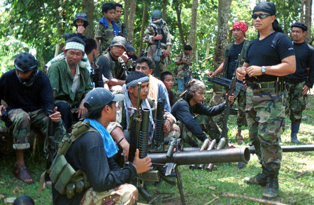 A group of armed Filipino Abu Sayyaf Group militants gather in this undated photo. [AP]