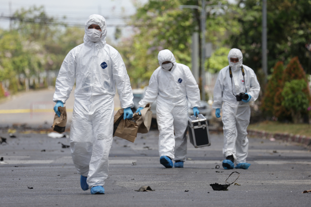 Police investigators arrive at the wreckage of car bomb following an explosion outside the  Southern Border Province Administration office in Yala March 17, 2020.(AFP)