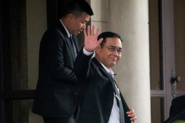 Thai junta chief Prayuth Chan-o-cha waves to photographers before leaving government house in Bangkok, June 5, 2019. [AP]