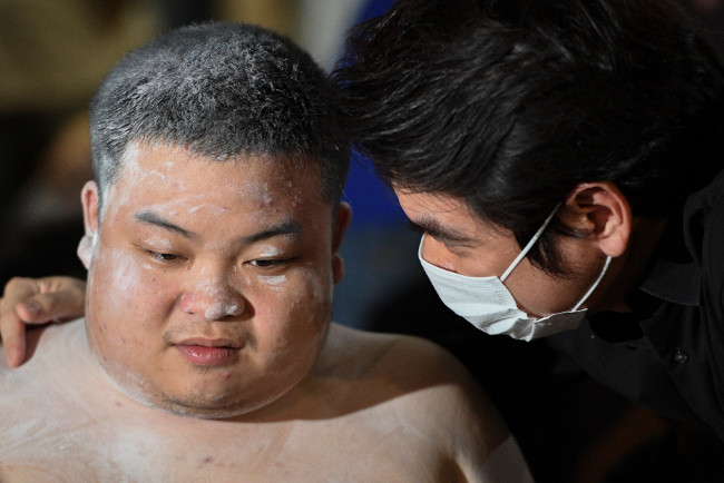 Piyabutr Saengkanokkul, a former Future Forward Party leader (right), speaks with student leader Parit Chiwarak in front of the Prachachuen police station in Bangkok, Oct. 30, 2020. (Reuters)