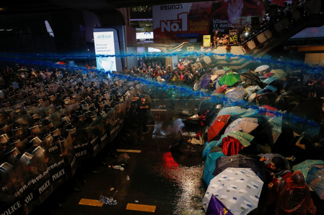 Thai police fire a water cannon containing a chemical dye at pro-democracy protesters in Bangkok, Oct. 16, 2020. (Reuters)