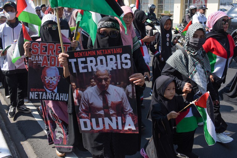 Para demonstran pro-Palestina memegang poster dalam aksi unjuk rasa mengecam serangan Israel di Gaza dan menyerukan boikot terhadap produk yang mereka anggap mendukung Israel, di Bandung, Jawa Barat, pada 13 Juli 2024. [Timur Matahari/AFP]