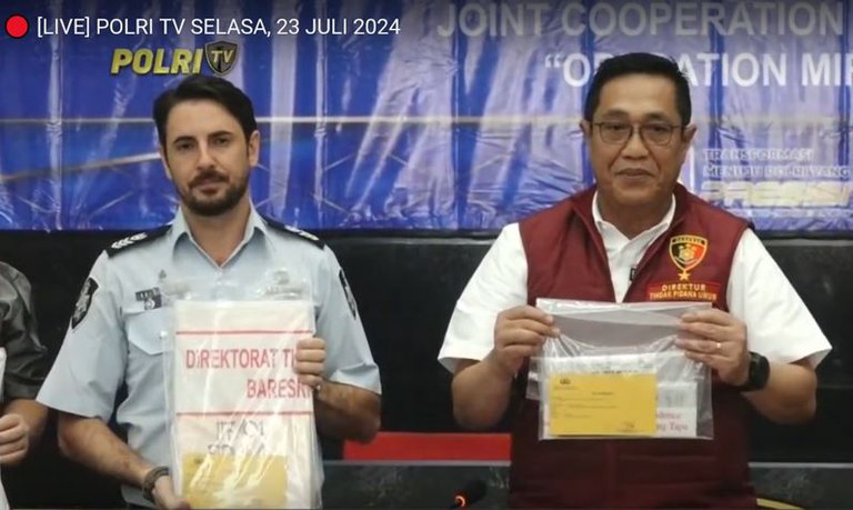 Direktur Reserse Kriminal Umum Polri Brigjen Pol. Djuhandhani Rahardjo Puro (kanan) bersama mitranya perwakilan dari Kepolisian Federal Australia memperlihatkan sejumlah barang bukti pengungkapan kasus perdagangan orang ke Australia sebagai pekerja seks dalam konferensi pers di Jakarta, 23 Juli 2024. [YouTube TV Radio Polri]